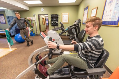 A patient is riding an Indoor Cycling Bike